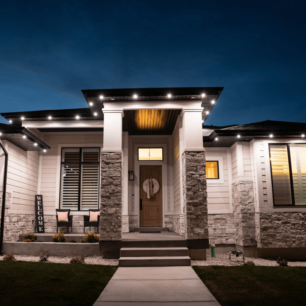 Permanent soffit lighting enhances the front porch of a home at night.