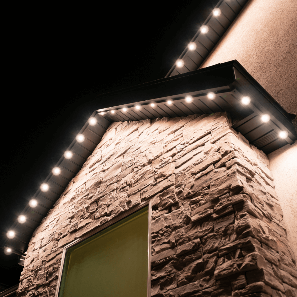 A series of warm, white soffit lights line a gable, illustrating that permanent Christmas lights don't have to stay festive all year.