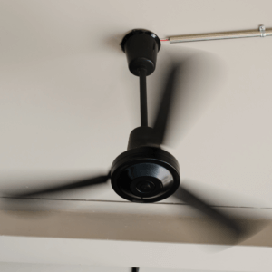 A fan rotates to provide ventilation to help air circulation when painters paint inside in the winter. 